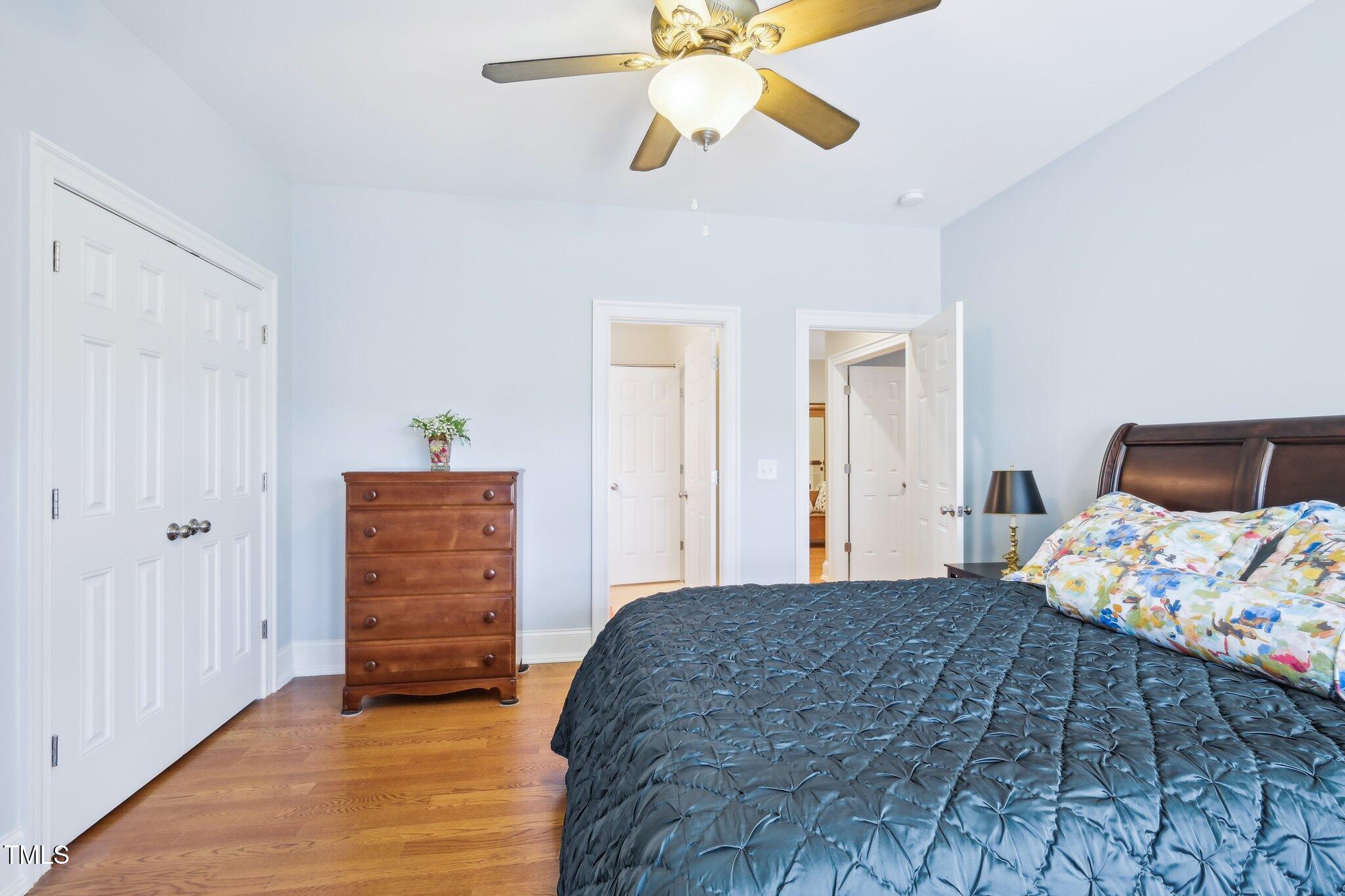 301 Kinsale Drive Durham, NC 27707 - Photo 47 of 68 a bedroom with a bed and a chandelier