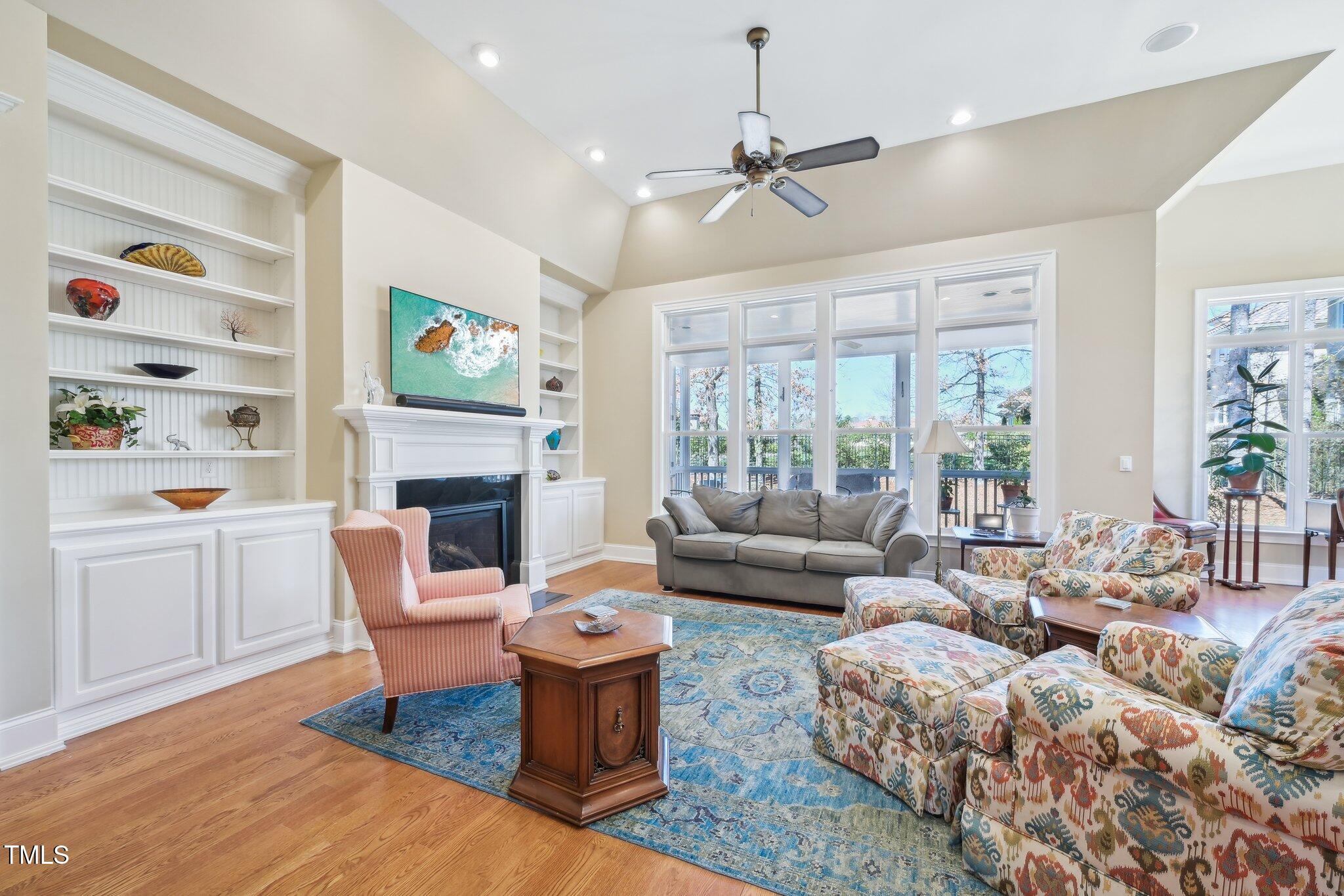 301 Kinsale Drive Durham, NC 27707 - Photo 7 of 68 a living room with furniture a fireplace and a flat screen tv