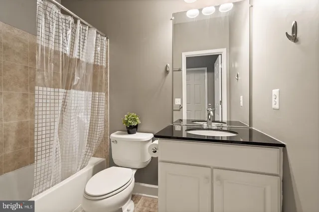 a bathroom with a toilet a sink and a mirror