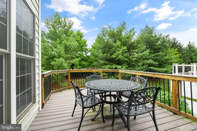 a view of a deck with a table and chairs with wooden floor