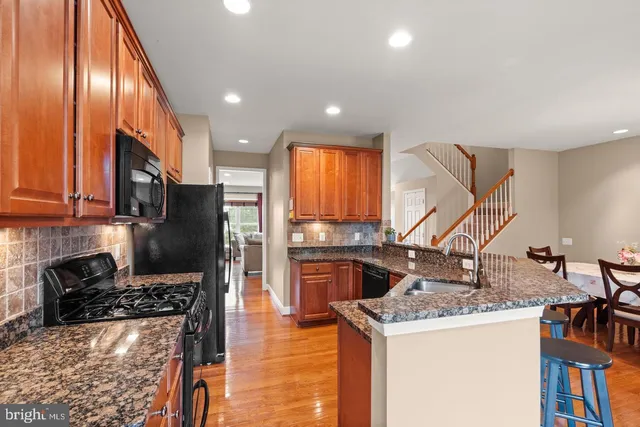 a kitchen with stainless steel appliances granite countertop a stove and a refrigerator