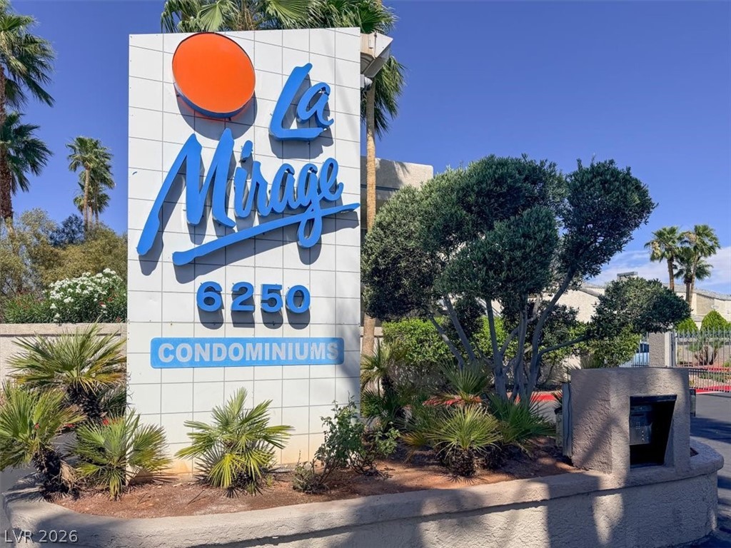 6250 West Flamingo Road, Unit 93 Las Vegas, NV 89103 - Photo 33 of 38 Welcome to La Mirage Condominiums, featuring a distinctive sign surrounded by lush landscaping.