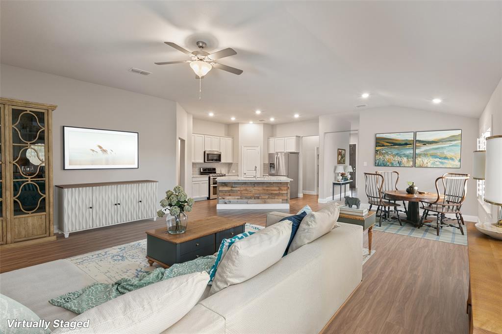 6909 Danridge Road Rowlett, TX 75089 - Photo 7 of 29 a living room with furniture kitchen view and a wooden floor