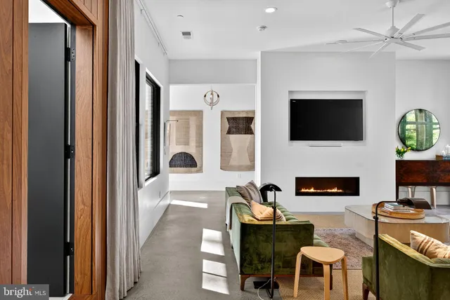 a dining room with furniture and a potted plant