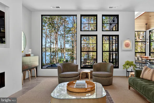 a living room with furniture and potted plants