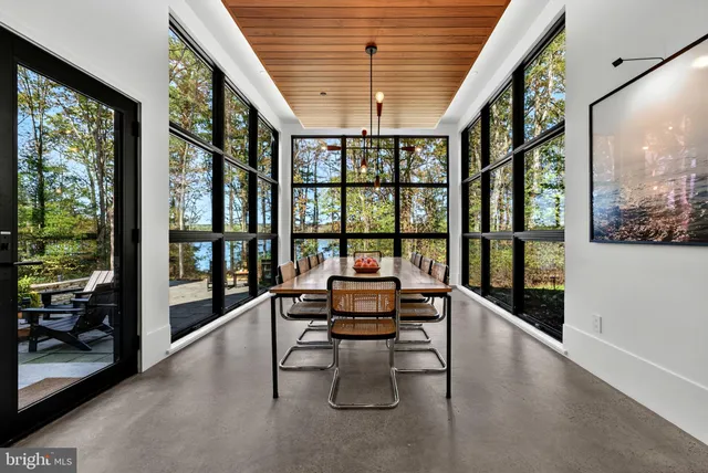 a view of yard with swimming pool and brick wall