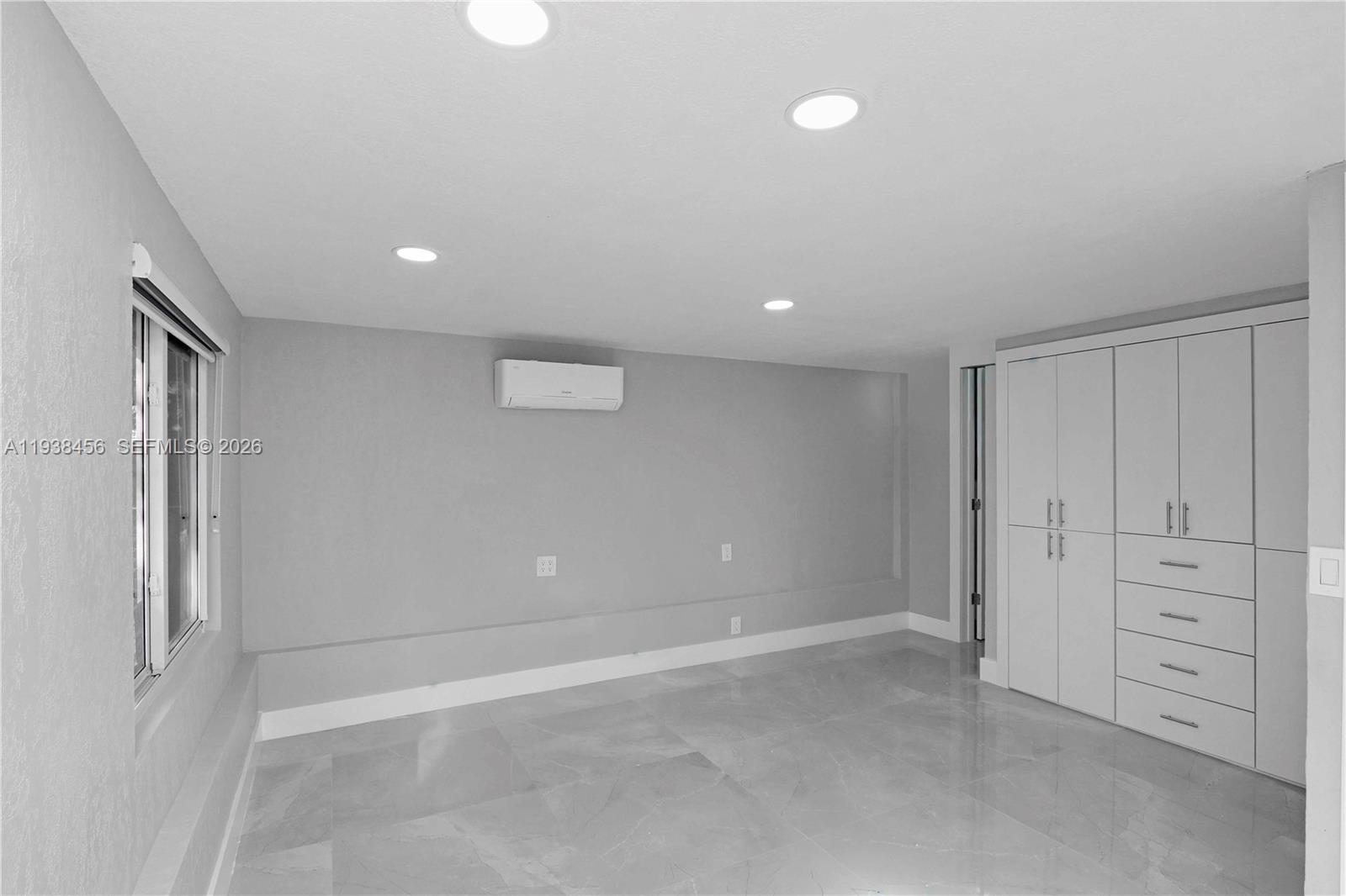 5730 Greene Street Hollywood, FL 33021 - Photo 12 of 27 wooden floor in an empty room with a window