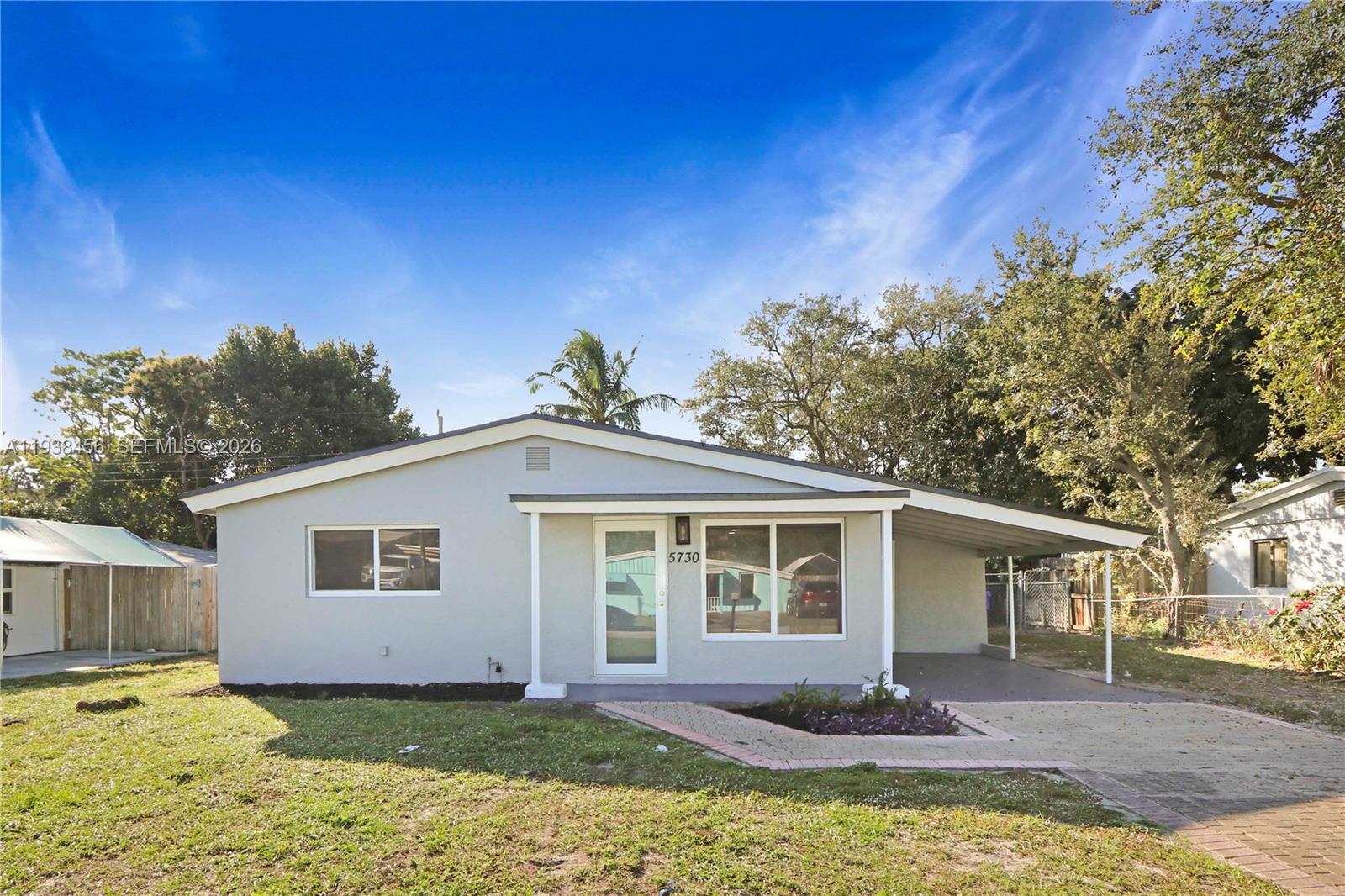 5730 Greene Street Hollywood, FL 33021 - Photo 2 of 27 a view of a house with a yard in the background