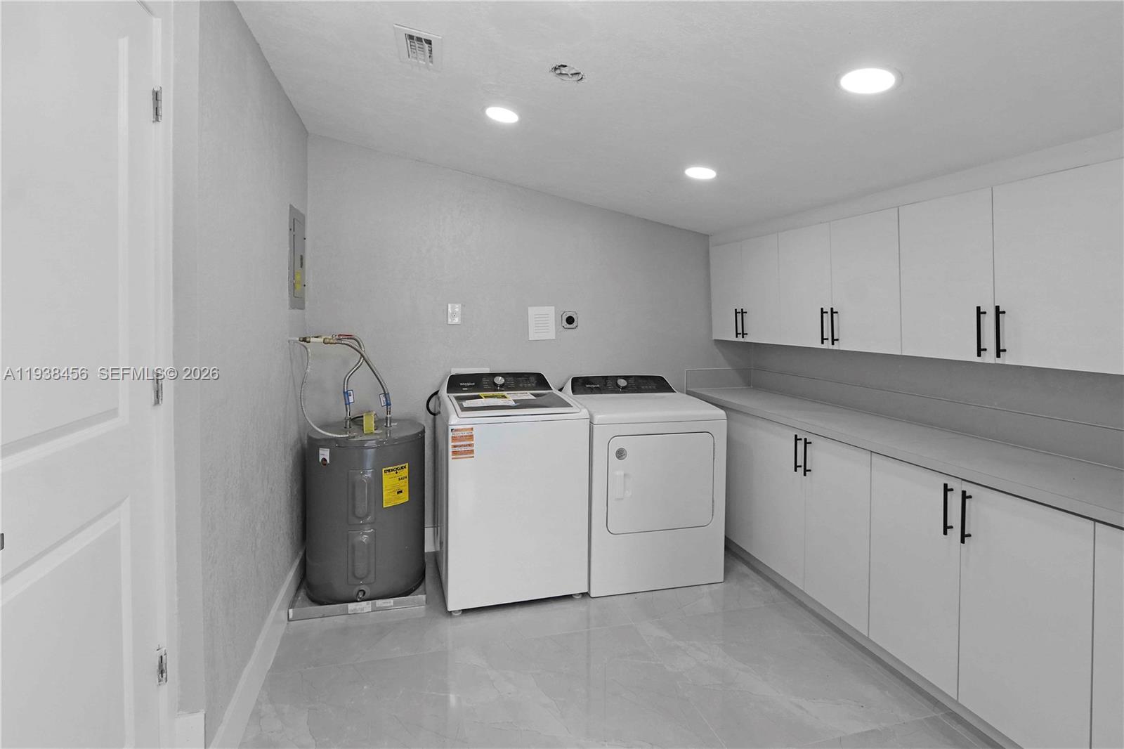 5730 Greene Street Hollywood, FL 33021 - Photo 21 of 27 a utility room with cabinets washer and dryer