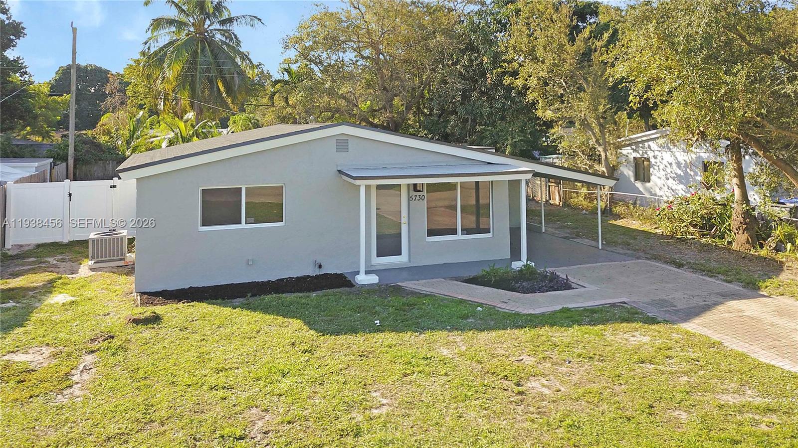 5730 Greene Street Hollywood, FL 33021 - Photo 25 of 27 a backyard of a house with yard and garage