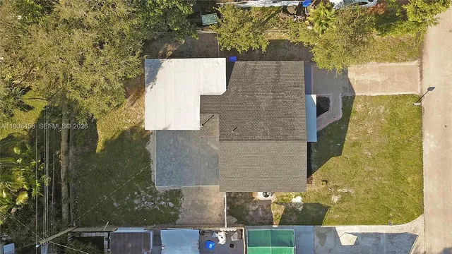 an aerial view of a house with a yard