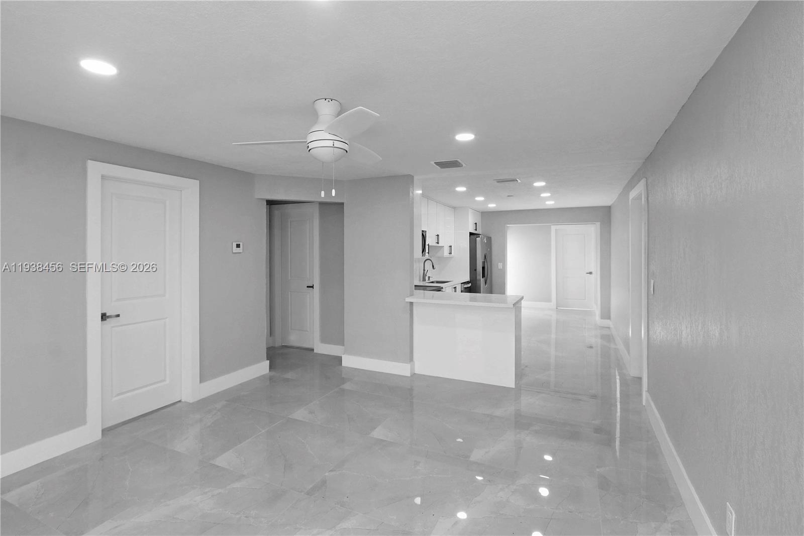 5730 Greene Street Hollywood, FL 33021 - Photo 4 of 27 a view of a hallway with kitchen and a refrigerator
