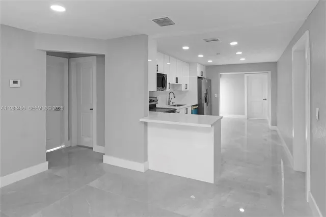 a bathroom with a sink a mirror and a vanity