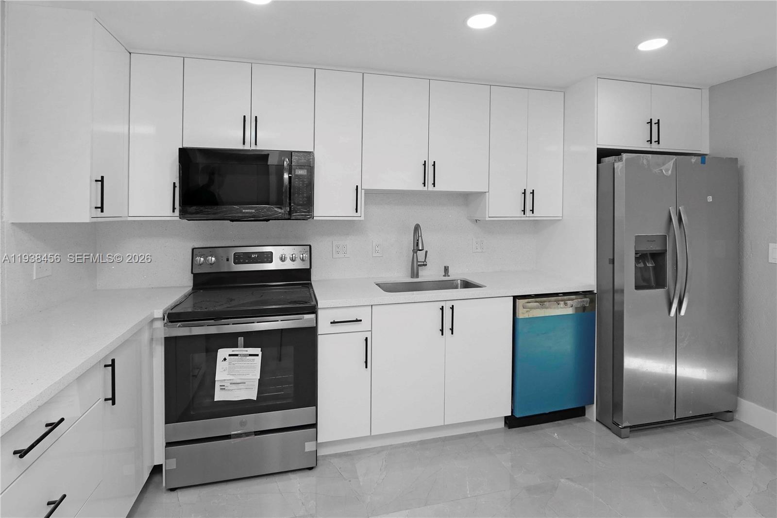 5730 Greene Street Hollywood, FL 33021 - Photo 9 of 27 a kitchen with cabinets stainless steel appliances and a counter space