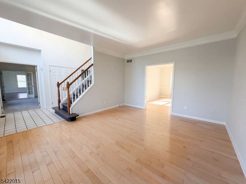 40 Glen Eagles Road Washington, NJ 07882 - Photo 16 of 38 a view of an empty room with wooden floor and stairs