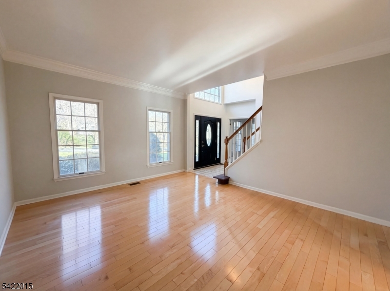 40 Glen Eagles Road Washington, NJ 07882 - Photo 17 of 38 an empty room with wooden floor and windows