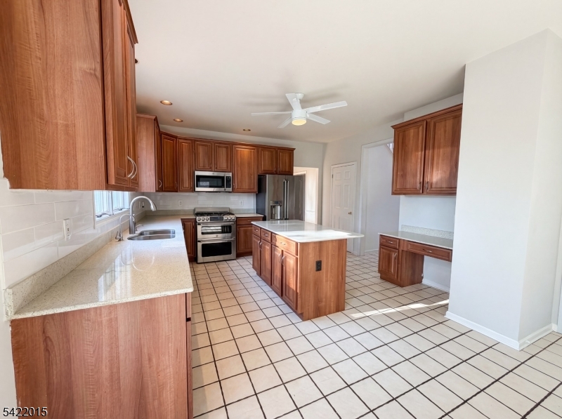 40 Glen Eagles Road Washington, NJ 07882 - Photo 21 of 38 a large kitchen with stainless steel appliances a stove a sink dishwasher and cabinets