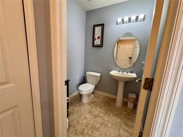 a bathroom with a toilet and a mirror