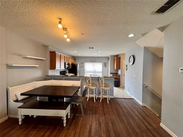 a dining room with furniture and wooden floor
