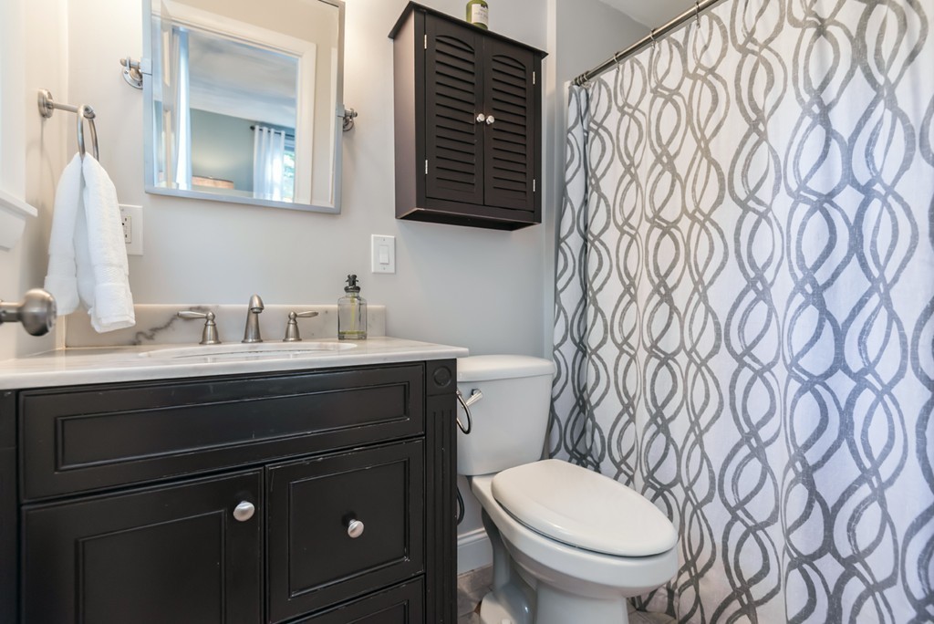 18 Strawberry Hill Road Andover, MA 01810 - Photo 15 of 23 a bathroom with a granite countertop toilet sink and mirror