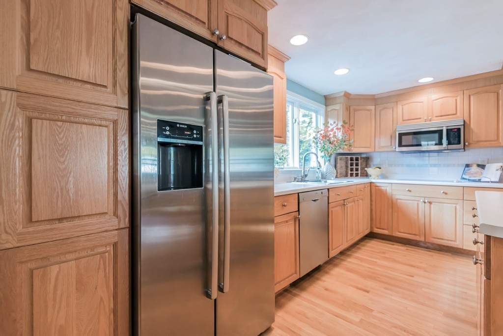 18 Strawberry Hill Road Andover, MA 01810 - Photo 8 of 23 a kitchen with stainless steel appliances granite countertop a refrigerator and a sink