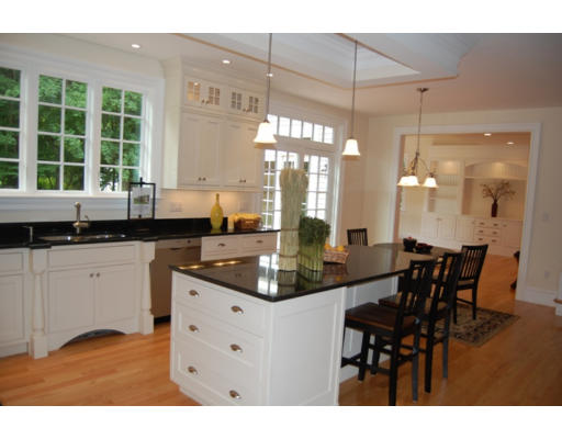 3 Graham Road Lexington, MA 02420 - Photo 8 of 26 a kitchen with kitchen island granite countertop a table chairs and white cabinets