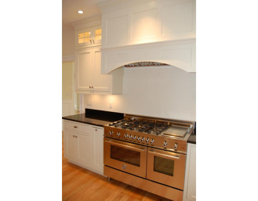 3 Graham Road Lexington, MA 02420 - Photo 9 of 26 a kitchen with granite countertop white cabinets and white appliances