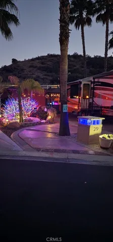 a view of a swimming pool with lawn chairs potted plants