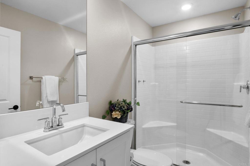 1751 Whitmore Loop Chula Vista, CA 91913 - Photo 11 of 44 a bathroom with a sink mirror toilet and bathtub