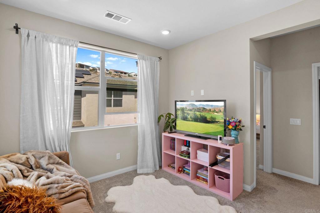 1751 Whitmore Loop Chula Vista, CA 91913 - Photo 12 of 44 a living room with furniture and a flat screen tv