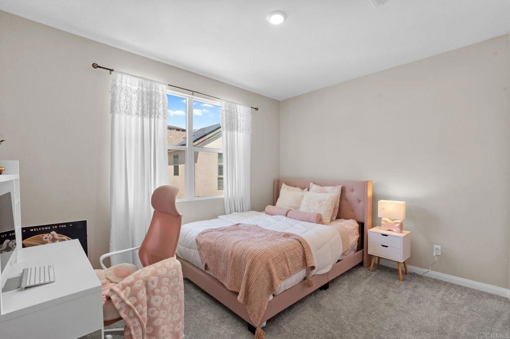 1751 Whitmore Loop Chula Vista, CA 91913 - Photo 14 of 44 a bedroom with a bed and large window