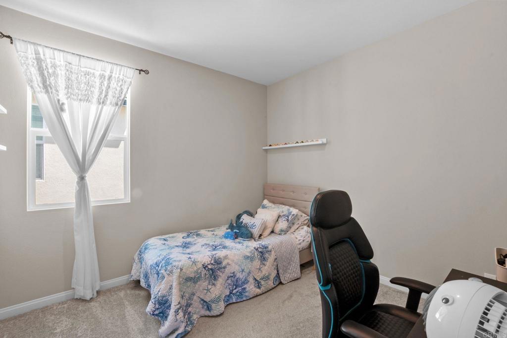 1751 Whitmore Loop Chula Vista, CA 91913 - Photo 16 of 44 a bedroom with a bed and a window