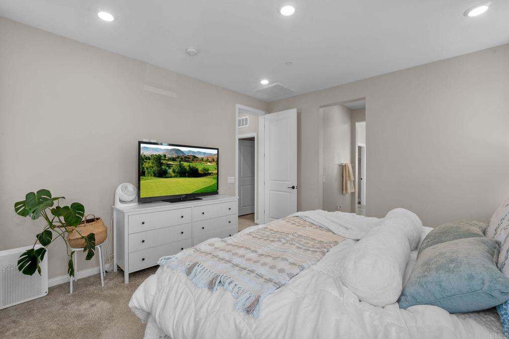1751 Whitmore Loop Chula Vista, CA 91913 - Photo 21 of 44 a bedroom with a bed and a flat screen tv