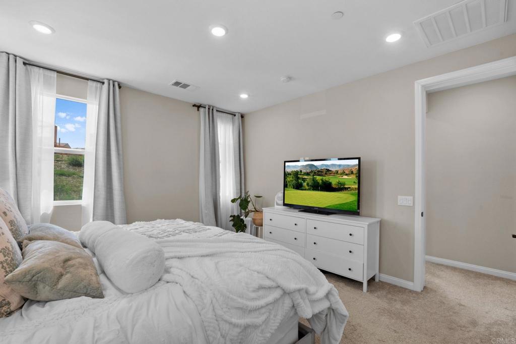 1751 Whitmore Loop Chula Vista, CA 91913 - Photo 22 of 44 a bedroom with a bed and a flat tv screen on dresser