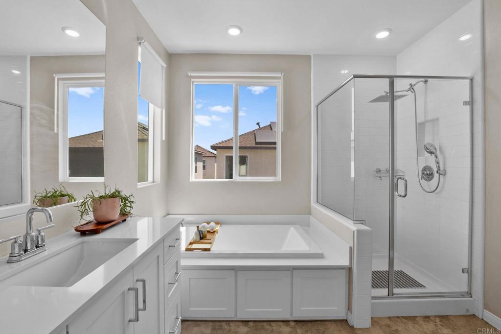 1751 Whitmore Loop Chula Vista, CA 91913 - Photo 24 of 44 a bathroom with a tub sink and mirror