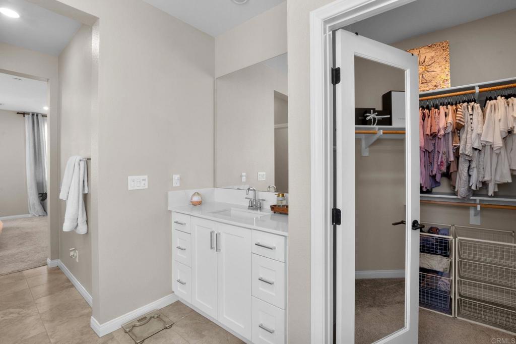 1751 Whitmore Loop Chula Vista, CA 91913 - Photo 25 of 44 a bathroom with a double vanity sink and mirror