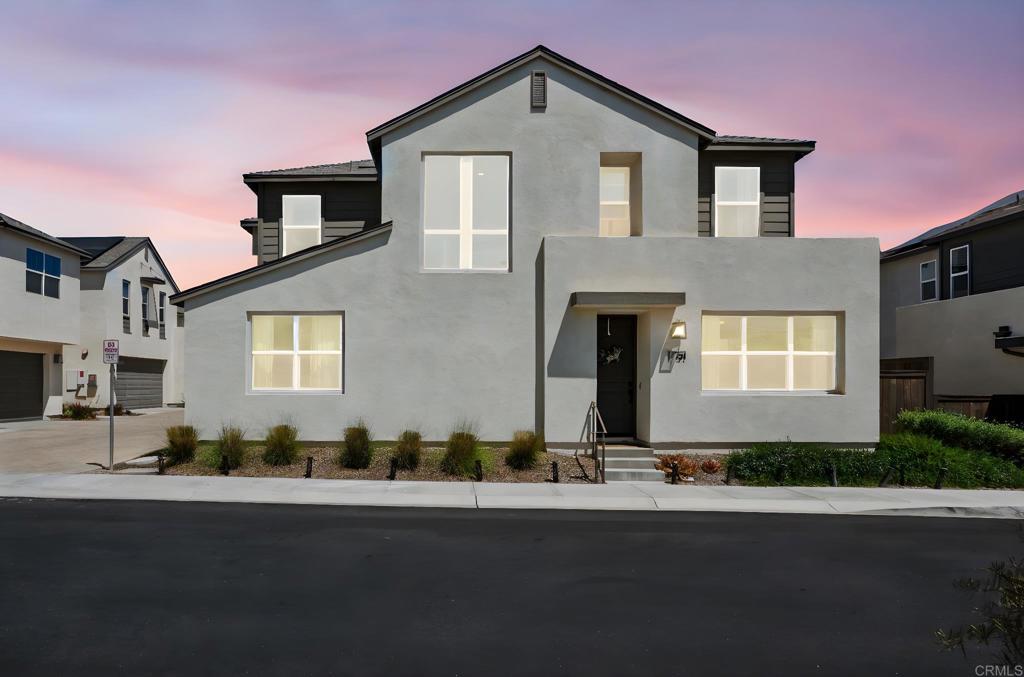 1751 Whitmore Loop Chula Vista, CA 91913 - Photo 43 of 44 a front view of a house with a yard and garage