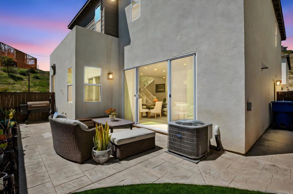 1751 Whitmore Loop Chula Vista, CA 91913 - Photo 44 of 44 a living room with furniture a flat screen tv and a floor to ceiling window