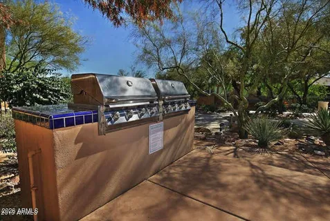 a view of a barbeque grill with a yard