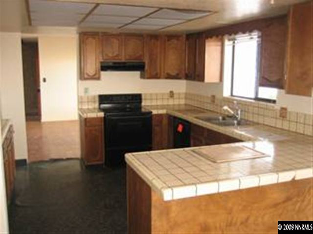 5450 Quaking Aspen Road Reno, NV 89510 - Photo 3 of 9 a kitchen with a sink a stove and cabinets