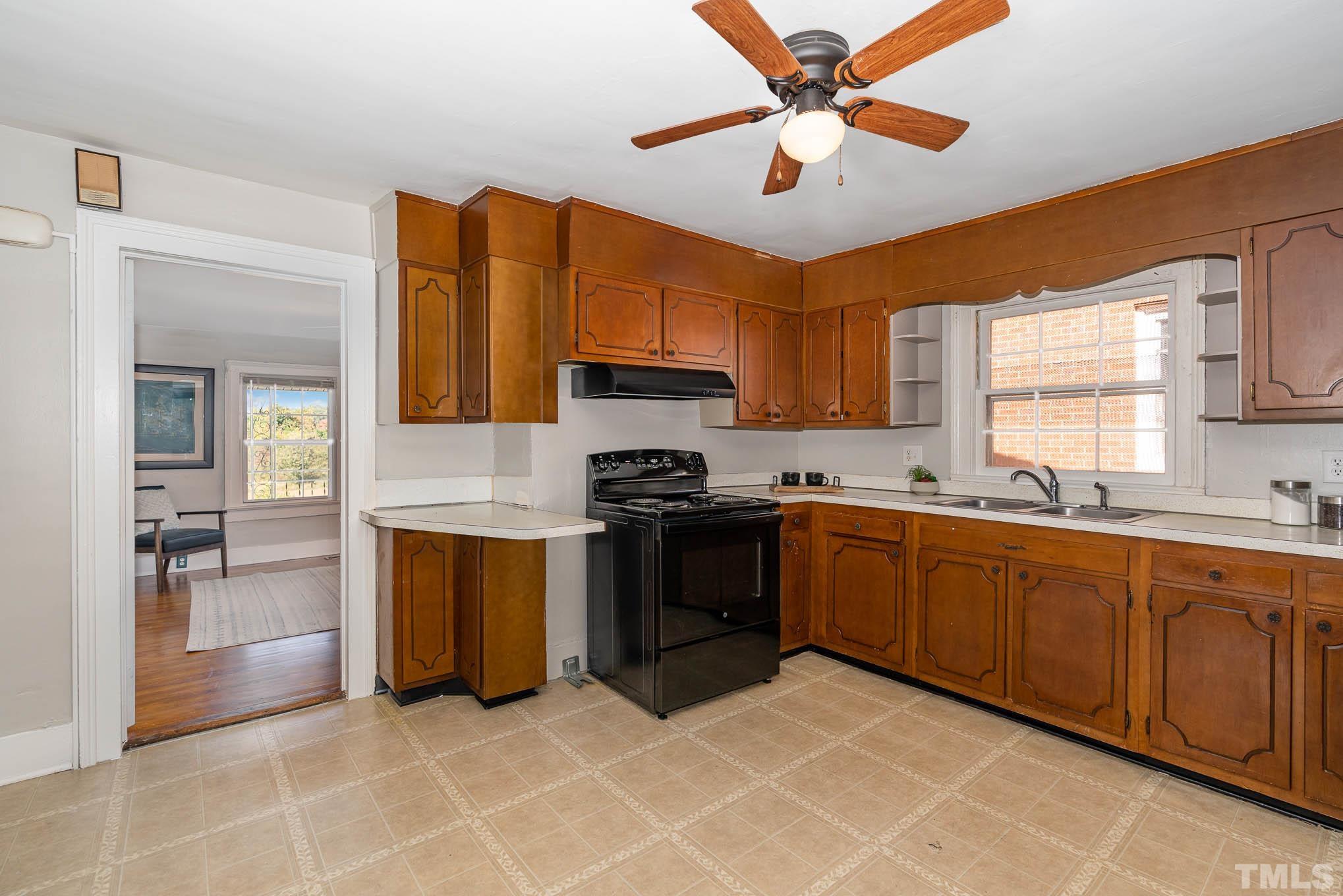 1415 Garner Road Raleigh, NC 27610 - Photo 12 of 15 a kitchen with stainless steel appliances granite countertop a stove top oven a sink a counter space and cabinets