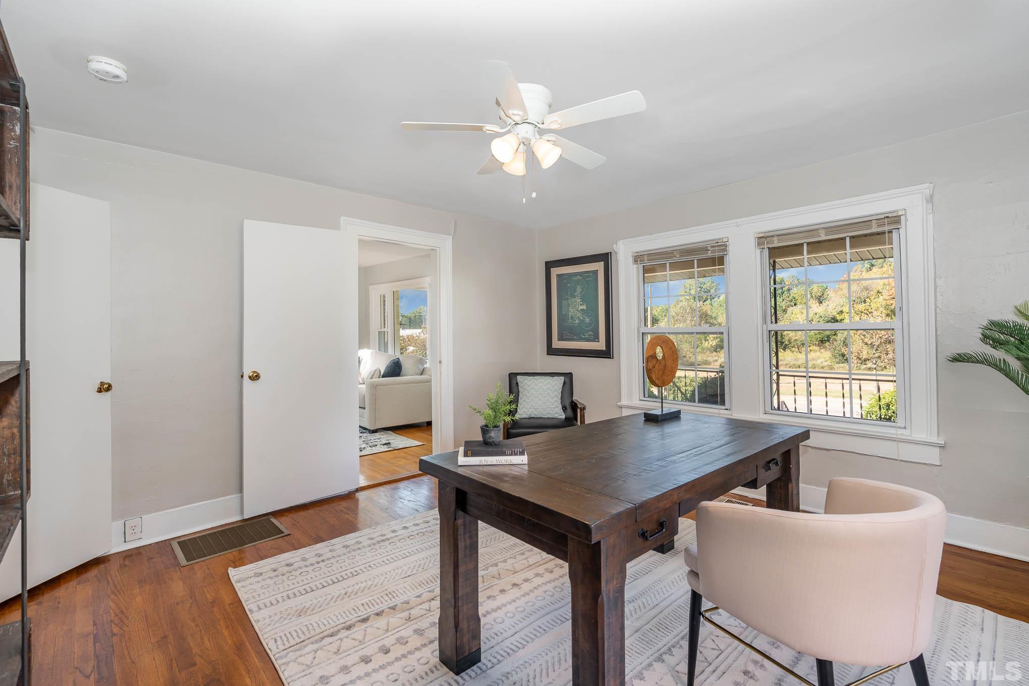 1415 Garner Road Raleigh, NC 27610 - Photo 7 of 15 a view of a dining room with furniture and wooden floor
