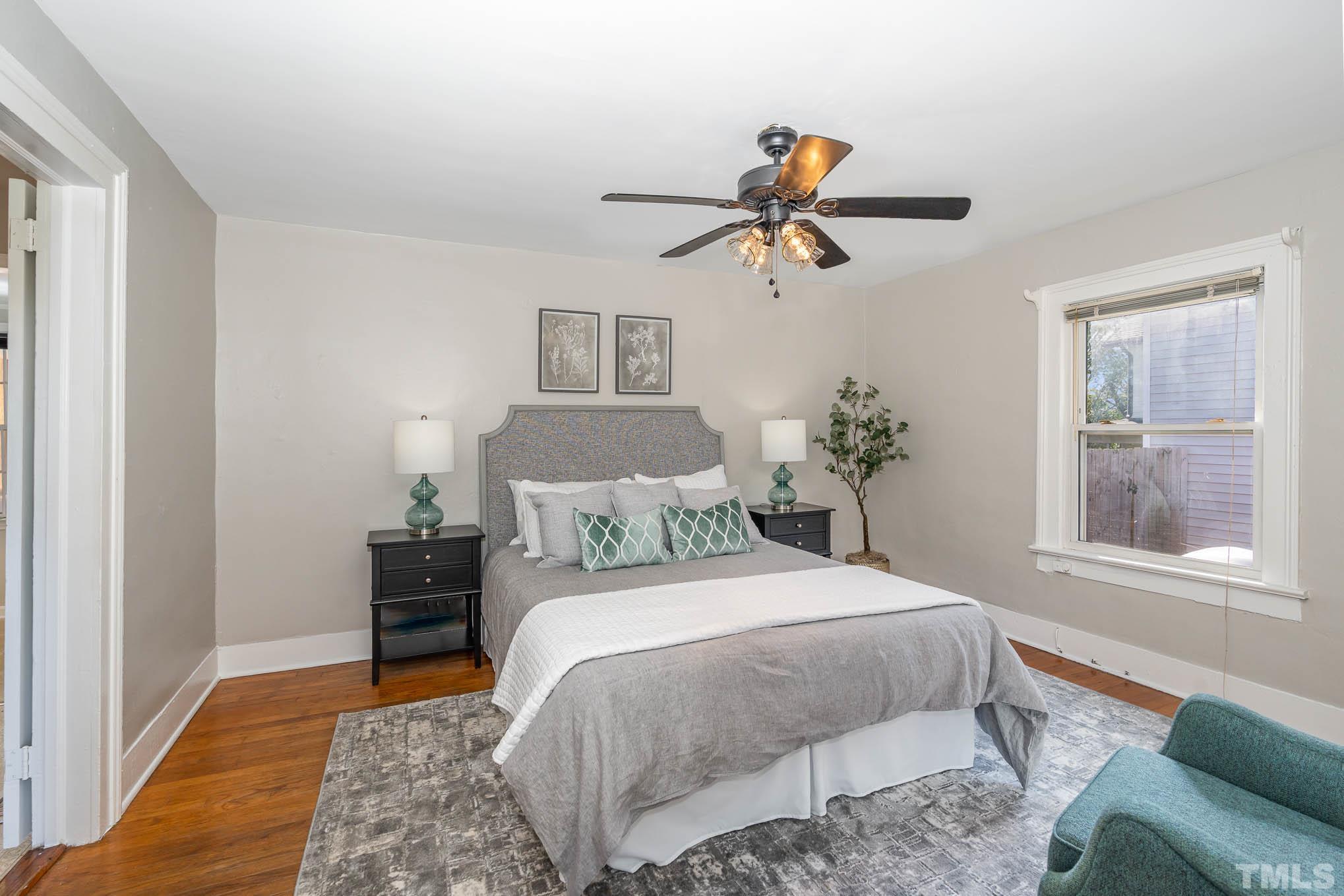 1415 Garner Road Raleigh, NC 27610 - Photo 8 of 15 a bedroom with a bed and wooden floor