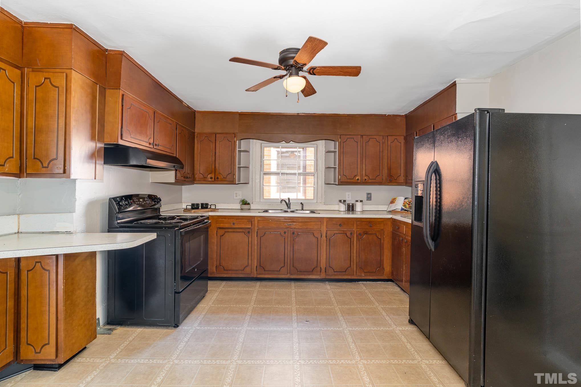 1415 Garner Road Raleigh, NC 27610 - Photo 10 of 15 a kitchen with a sink stainless steel appliances and cabinets