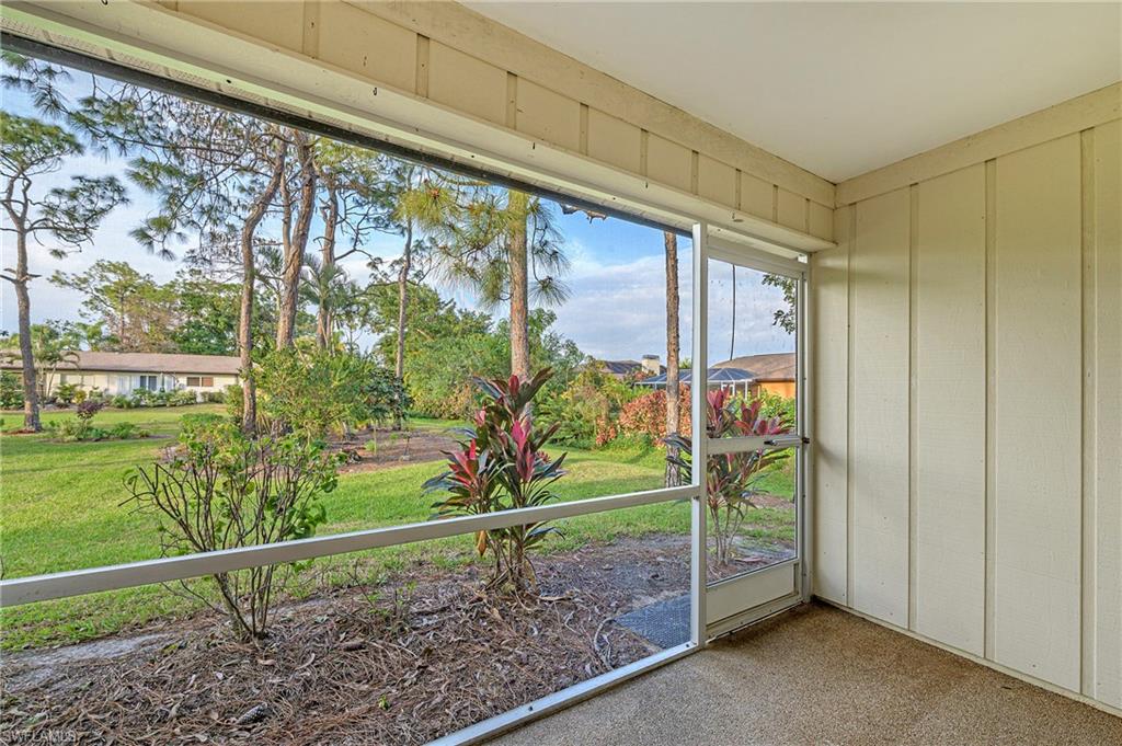 1007 Pine Isle Lane, Unit 1007 Naples, FL 34112 - Photo 15 of 20 a view of a porch with a yard