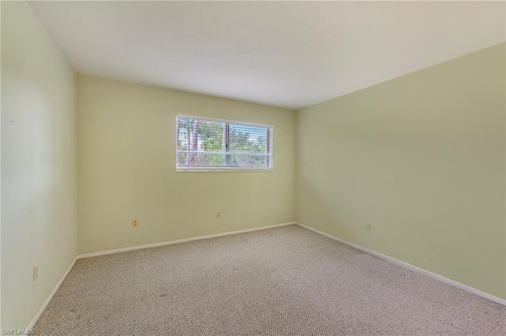 1007 Pine Isle Lane, Unit 1007 Naples, FL 34112 - Photo 10 of 20 an empty room with a empty space and window