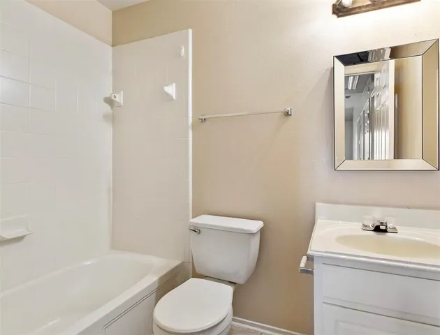 a bathroom with a toilet and a bathtub