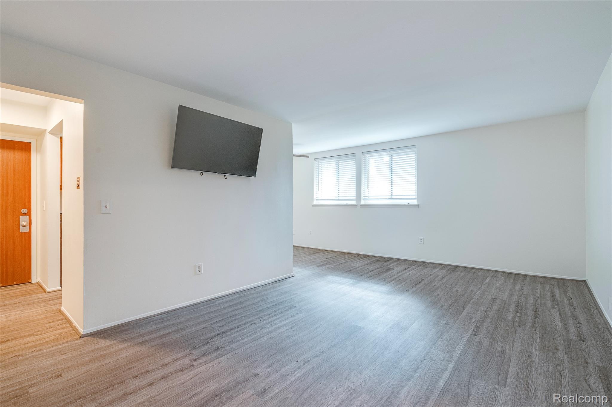 29860 West 12 Mile Road, Unit 604 Farmington, MI 48334 - Photo 8 of 26 Unfurnished living room with light wood-style floors and baseboards