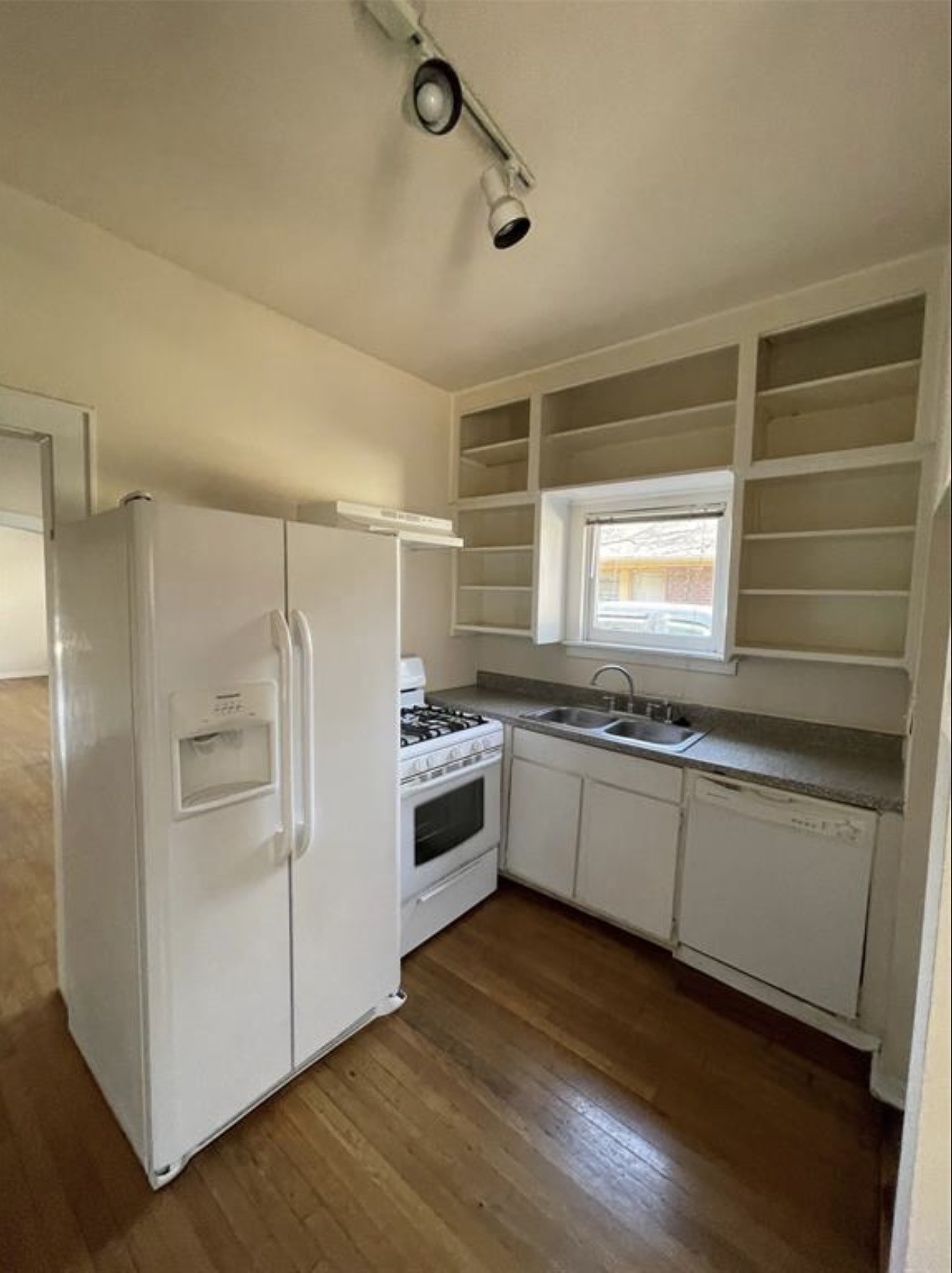 1706 Hawthorne Street Houston, TX 77098 - Photo 12 of 25 a kitchen with granite countertop white cabinets and white appliances