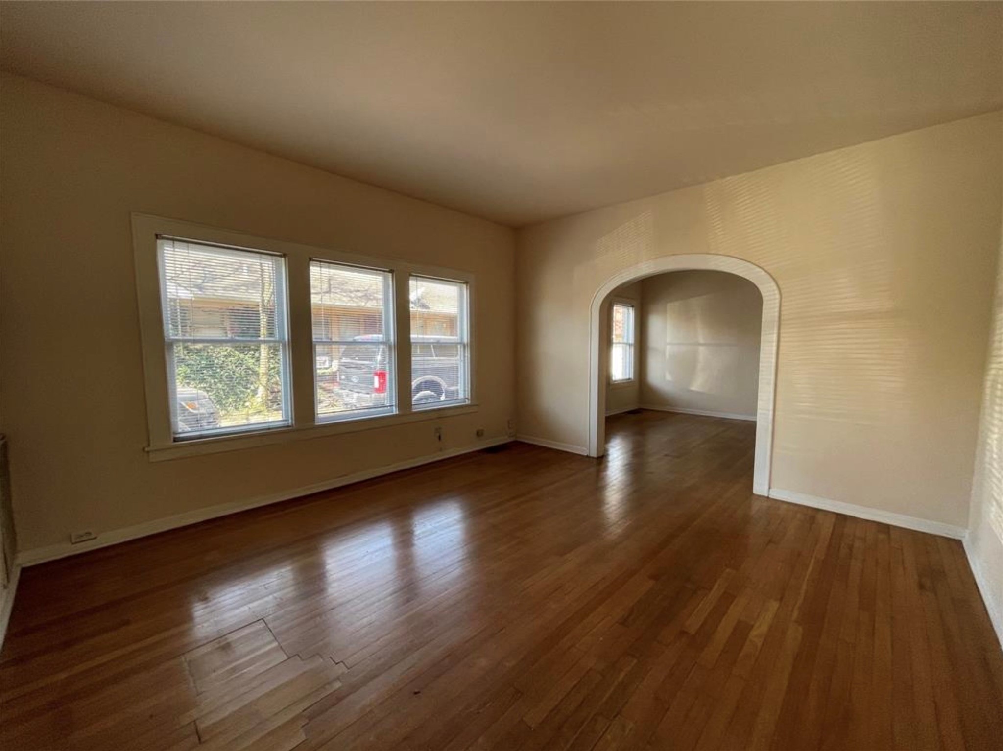 1706 Hawthorne Street Houston, TX 77098 - Photo 2 of 25 an empty room with wooden floor and windows
